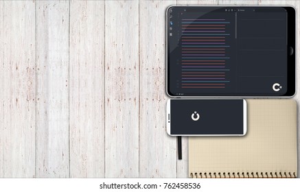 phone, tablet and notepad on the table. Software. Programming.