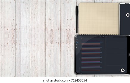 phone, tablet and notepad on the table. Software. Programming.