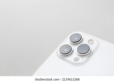 phone with three cameras in the background.