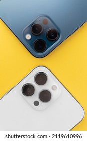 phone with three cameras in the background.yellow background - Shutterstock ID 2119610996