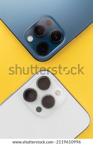 phone with three cameras in the background.yellow background