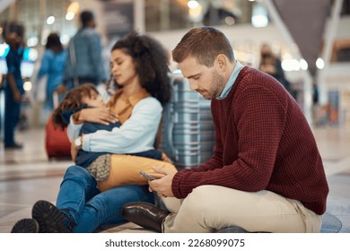 Phone, tired and interracial family waiting at the airport for a delayed flight. Contact, late and man on a mobile app with a black woman and child sleeping during problems with travel on a trip - Shutterstock ID 2268099075
