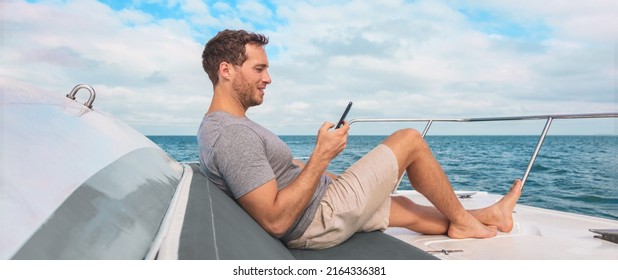 Phone Using On Cruise Ship. Man Luxury Travel Texting With Data On Yacht Boat Relaxing On Deck Banner Panoramic. Caribbean Vacation