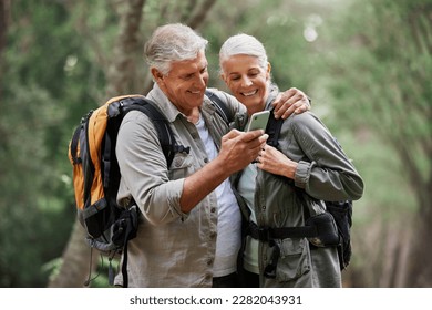 Phone, video call and elderly couple hiking in a forest, happy and smile while bonding on adventure. Active seniors, online and maps for man and woman backpacking in nature while checking location - Powered by Shutterstock