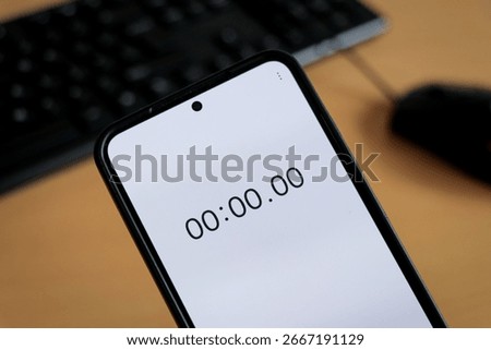 Phone white stopwatch timer to study on office keyboard, study business background