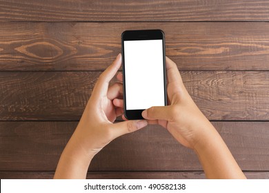 Phone In Woman Hand Showing White Screen On Wood Table, Mockup New Phone Style Jet Black Color