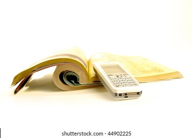 Phonebook with yellowpages isolated on white background with silver cellphone