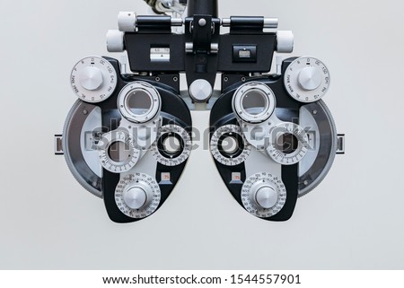 phoropter close up view of ophthalmology, optometry, and optician clinical testing machine equipment against a white background