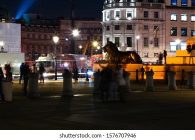 Phot taken trafalgar square London United Kingdom on the 22nd November 2019. Photo portrays night scene with pedestrians at rush hour. The photo shows buildings, staues and historic monuments.