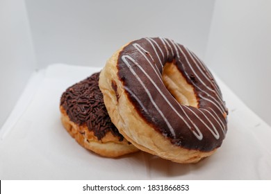 Photo From Above Double Donut With Chocolate  Icing And Cream On White Isolated