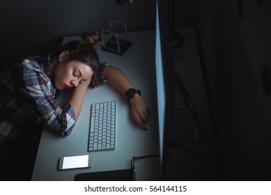 Photo From Above Of A Young Female Sleeping At Night Shift In The Office.