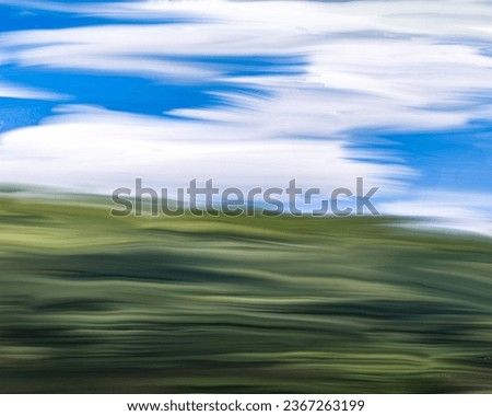 photo of an abstract painting with a forest and sky theme