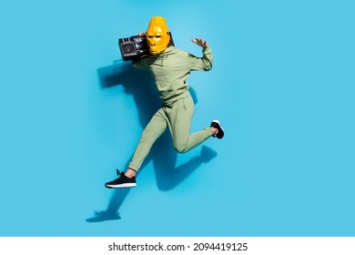 Photo of active street style guy jump hold shoulder boombox wear gorilla mask sportswear isolated blue color background