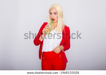 Photo of adorable blonde businesswoman smiling and holding cup of vitamin water isolated over white background