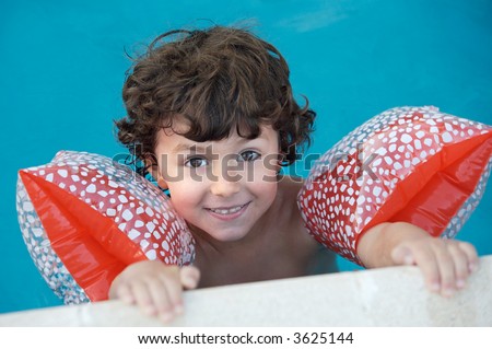 photo of an adorable boy learning to swim