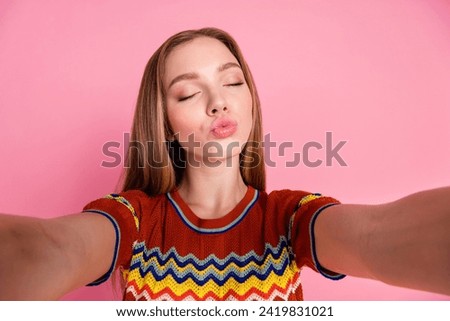 Photo of adorable cute girl take selfie record video closed eyes pouted lips kiss isolated on pink color background