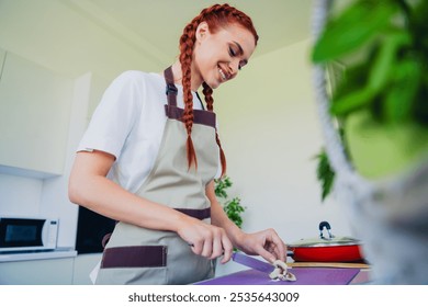 Photo of adorable cute girl wearing apron cooking meal dinner kitchen home house day light indoors - Powered by Shutterstock