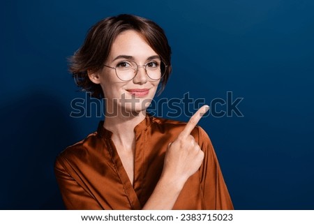 Photo of adorable cute lady wear trendy clothes arm direct empty space news benefit isolated on dark blue color background