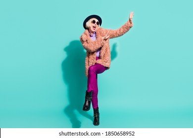 Photo Of Adorable Cute Old Woman Dressed Vintage Outerwear Cap Eyewear Dancing Isolated Turquoise Color Background