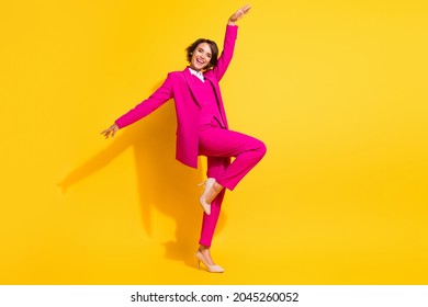 Photo of adorable cute young lady wear pink suit smiling dancing isolated yellow color background