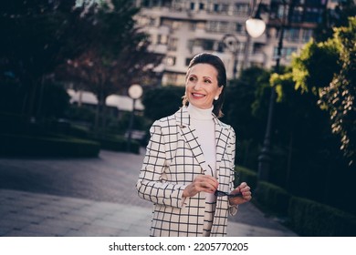 Photo Of Adorable Dreamy Woman Wear Plaid Jacket Walking Enjoying Sunny Weather Outside Urban Residential Complex