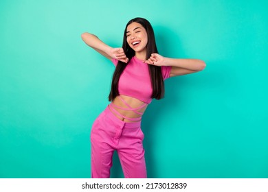 Photo Of Adorable Female In Trendy Set Of Clothes Feel Free Dancing In Club Isolated On Teal Color Background