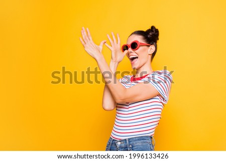 Photo of adorable funky young girl dressed striped t-shirt dark glasses dancing arms nose isolated yellow color background