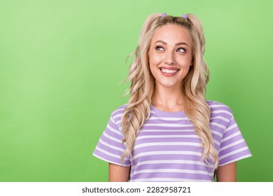 Photo of adorable girl with curly hairdo dressed striped t-shirt look empty space dental clinic ad isolated on green color background - Powered by Shutterstock