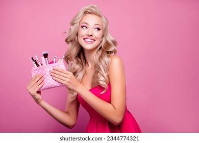Photo of adorable girly lady hold bag with cosmetics new doll collection for perfect look ads on pink background