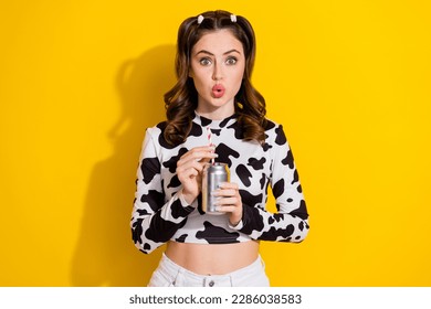 Photo of adorable impressed girl wear cow skin shirt drinking coca cola coke isolated yellow color background