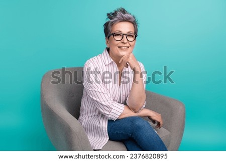 Photo of adorable lady trader banker wear white stylish clothes sitting chair hand touch chin think isolated on cyan color background