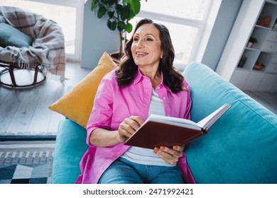 Photo of adorable lovely dreamy senior woman sitting sofa reading book comfy flat - Powered by Shutterstock