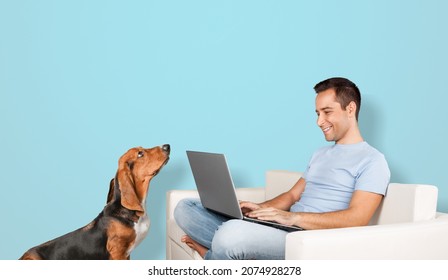 Photo Of Adorable Man Hold Pc Play Funny Dog