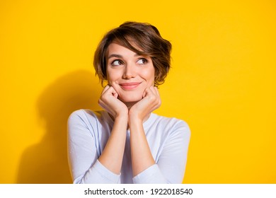 Photo of adorable positive lady look empty space hands cheeks wear white shirt isolated yellow color background - Shutterstock ID 1922018540