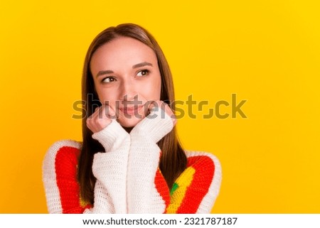 Photo of adorable positive lady look empty space hands cheeks wear white shirt isolated yellow color background.