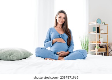 Photo of adorable pretty tender mom sitting in bed enjoying pregnancy home weekend morning white room interior indoors - Powered by Shutterstock