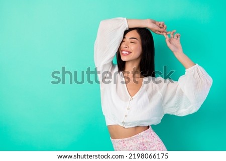 Photo of adorable sweet cute lady raise arms up enjoy armpit smell use deodorant cosmetics isolated cyan color background