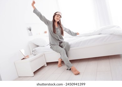 Photo of adorable sweet lady wear grey nightwear sitting bed stretching indoors apartment bedroom - Powered by Shutterstock