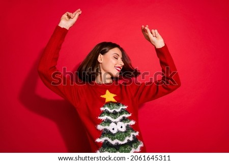 Photo of adorable sweet young woman wear ornament sweater dancing enjoying new year time isolated red color background