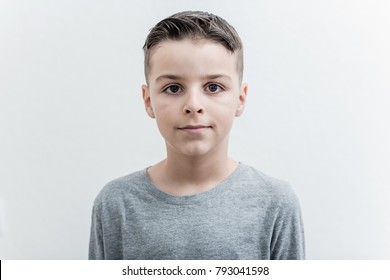 Photo of adorable young happy boy looking at camera.Isolated on the white background