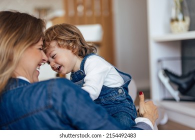 Photo Of An Adult Mom And Her Male Toddler, Smiling At Each Other.