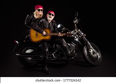 Photo Of Aged Bikers Man Lady Couple Sit Chopper Moto Feel Young Rock Bike Festival Meeting Play Sing Guitar Band Wear Trendy Rocker Leather Jacket Pants Isolated Black Color Background