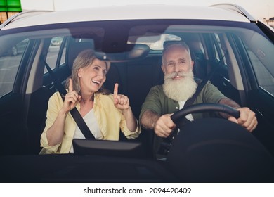 Photo of aged cheerful couple ride auto transport drivers license have fun dance point fingers laugh voyage weekend outside - Powered by Shutterstock