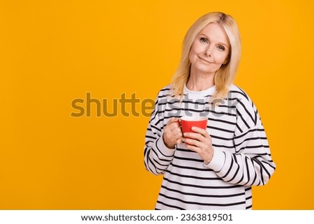 Photo of aged lady hold drink aromatic hot chocolate with fresh high quality beans isolated shine color background