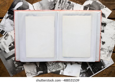 Photo Album And Old Black And White Photos On A Wooden Background Mockup