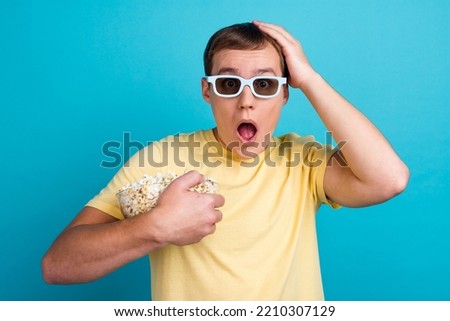 Similar – surprised boy with popcorn and television remote control on blue background