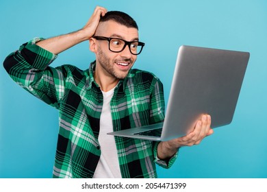 Photo Of Amazed Cheerful Happy Man Hold Computer Look Screen Work Programmer Isolated On Blue Color Background