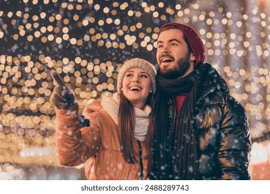 Photo of amazed girfriend point index finger evening illumination sky boyfriend look x-mas christmas magic atmosphere wear coat scarf hat - Powered by Shutterstock