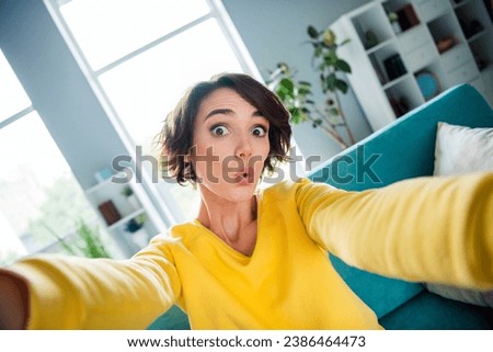Photo of amazed lady feel impressed make selfie on blog camera in modern apartment