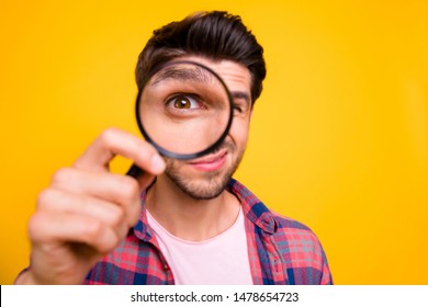 Photo Of Amazed Man Trying To See Microorganisms With Loupe But He Evidently Cannot Manage To Do It While Isolated With Yellow Background